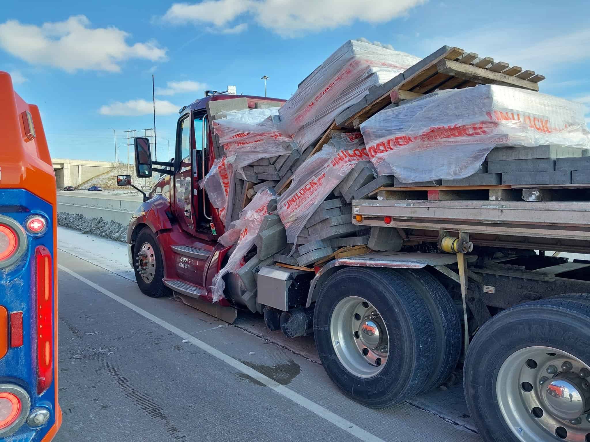 Big truck drops its load on Highway 401 in Mississauga