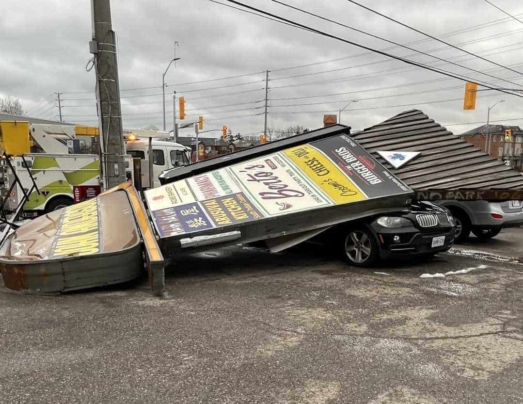 Hamburger joint sign falls onto vehicle in parking lot in Mississauga