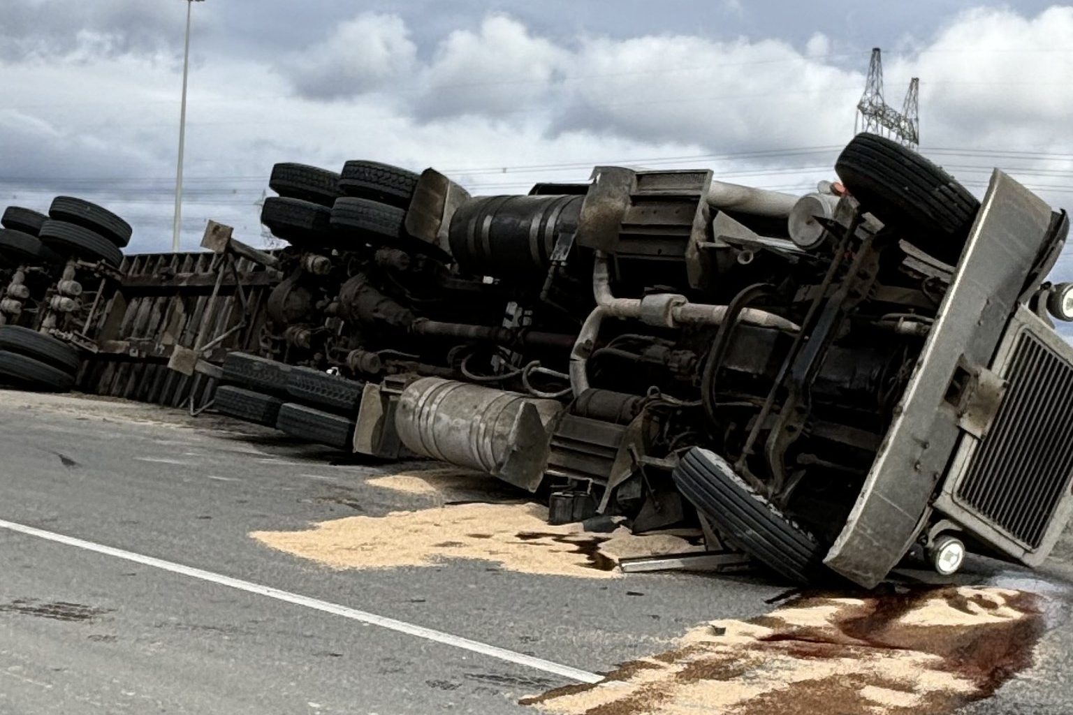 Transport truck rollover crash closes highway ramp for hours near Brampton border